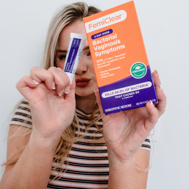 A woman holding FemiClear for bacterial vaginosis relief, showcasing a natural remedy option for managing BV symptoms effectively.
