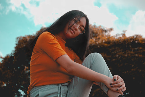 A woman holding a pack of birth control pills, highlighting questions about their potential effects on vaginal health, including yeast infections and UTIs