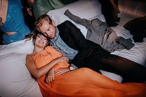 A woman having a stressful moment in bed worrying about if stress can cause a herpes outbreak.