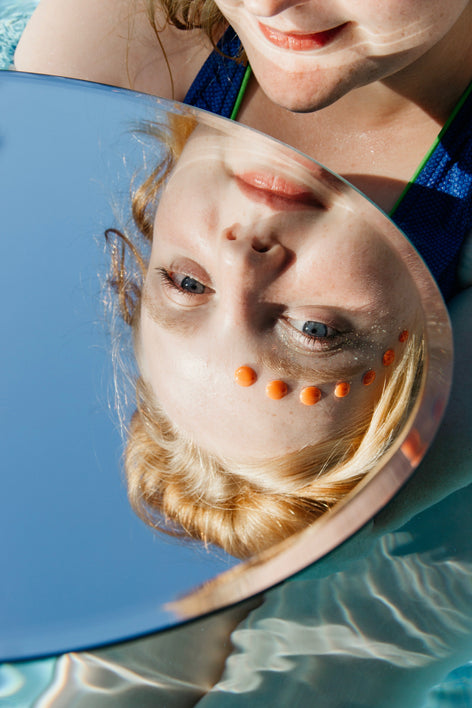 Boric Acid natural alternative - woman walking in a sunflower field - FemiClear