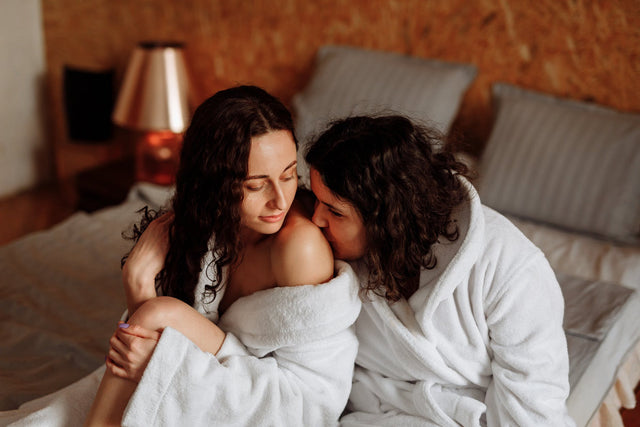 Two women sitting on a bed together