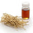 Bundle of dried pale roots beside a small glass bottle of amber oil with a white cap, on white.